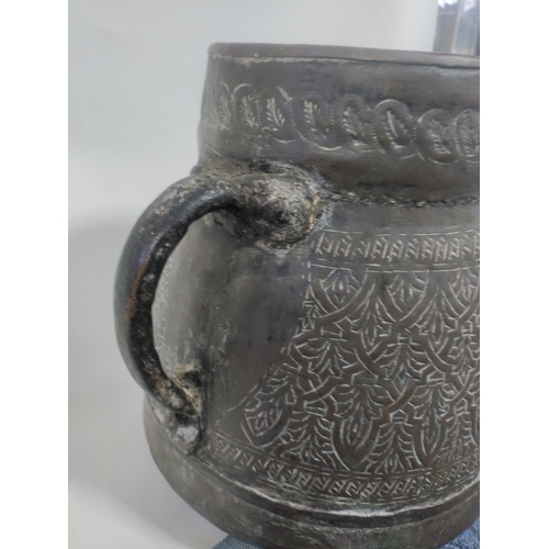 25 - A large Persian embossed brass bucket vessel with handles. H 28cm x W 31cm