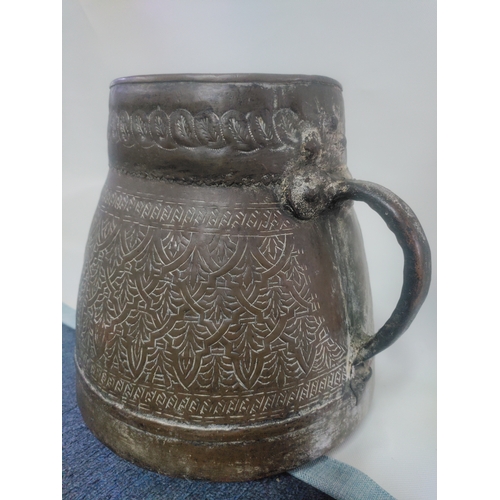 25 - A large Persian embossed brass bucket vessel with handles. H 28cm x W 31cm