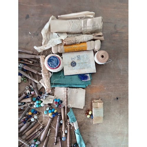 89 - A collection of vintage sewing bobbins, thread and thimbles to include a hallmarked silver thimble.