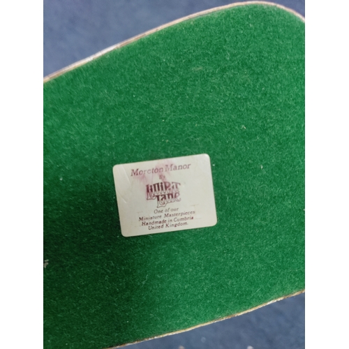 40 - A collection of Beswick Airedale terrier, a sandicast Airedale terrier, and Moreton manor by Lillipu... 