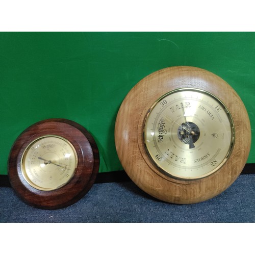 55 - A pair of wooden barometers.