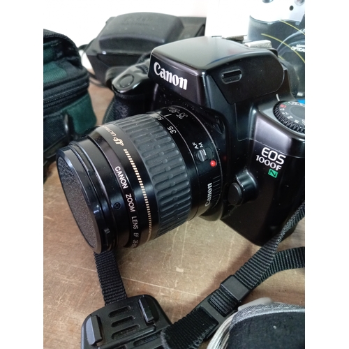 57 - A collection of cameras and equipment to include an olympia DL3000R new in the box, Two Canon EOS 10... 