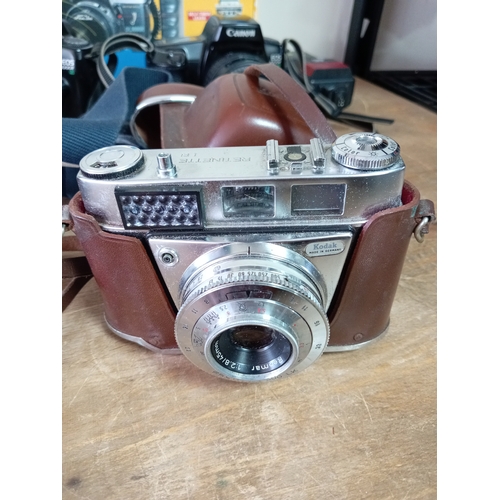 57 - A collection of cameras and equipment to include an olympia DL3000R new in the box, Two Canon EOS 10... 