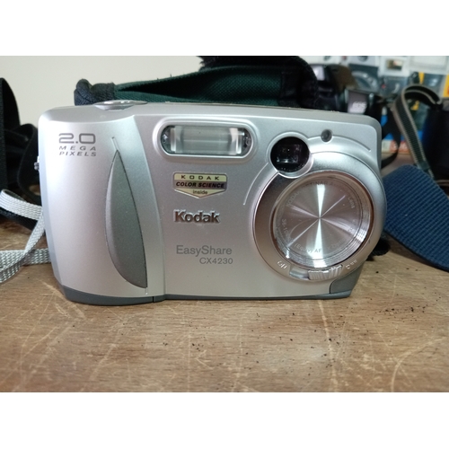 57 - A collection of cameras and equipment to include an olympia DL3000R new in the box, Two Canon EOS 10... 