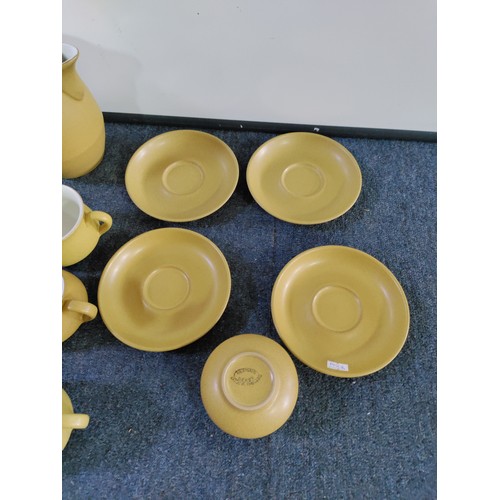 46 - A Denby Ware tea set. To include; 9 cups and 4 saucers, a teapot, sugar bowl, 4 egg cups and milk ju... 