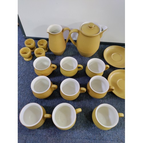 46 - A Denby Ware tea set. To include; 9 cups and 4 saucers, a teapot, sugar bowl, 4 egg cups and milk ju... 