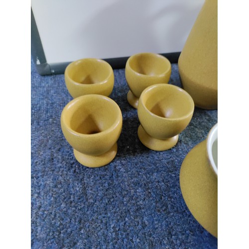 46 - A Denby Ware tea set. To include; 9 cups and 4 saucers, a teapot, sugar bowl, 4 egg cups and milk ju... 