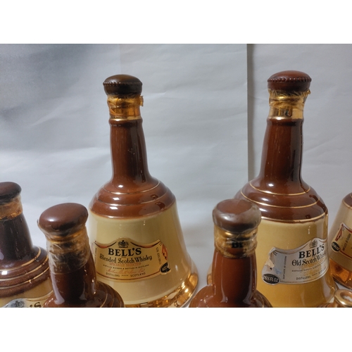 261 - A Collection of eight Bell's Blended Scotch Whisky in Ceramic bottles (varying sizes) - Mostly Broke... 