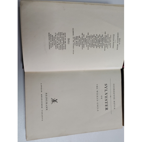 212 - A pair of Georgette Heyer books. One is Sylvester 1957 and Venetia 1958.