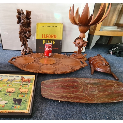 12 - A job lot of mainly wooden ethnic items to include: a carved statue; a carved mask; a carved tray; a... 