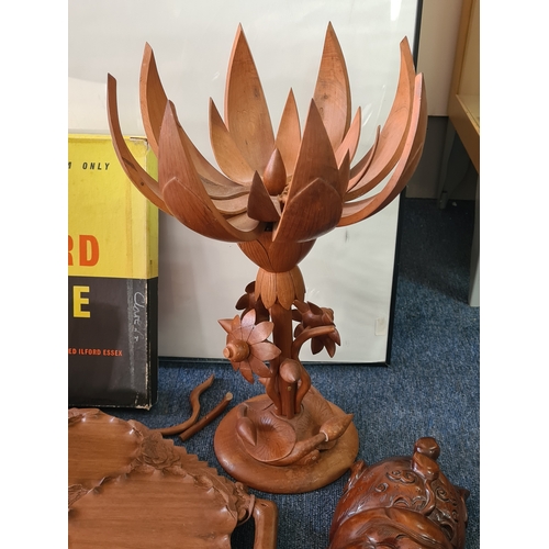 12 - A job lot of mainly wooden ethnic items to include: a carved statue; a carved mask; a carved tray; a... 