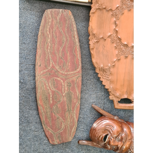 12 - A job lot of mainly wooden ethnic items to include: a carved statue; a carved mask; a carved tray; a... 