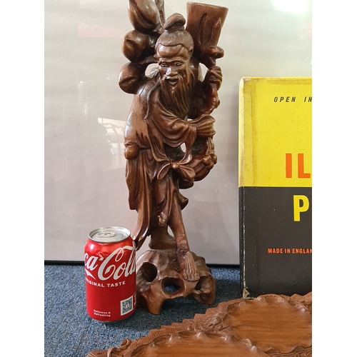 12 - A job lot of mainly wooden ethnic items to include: a carved statue; a carved mask; a carved tray; a... 