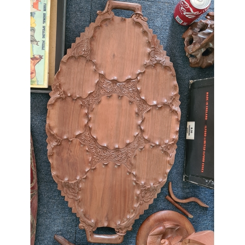 12 - A job lot of mainly wooden ethnic items to include: a carved statue; a carved mask; a carved tray; a... 