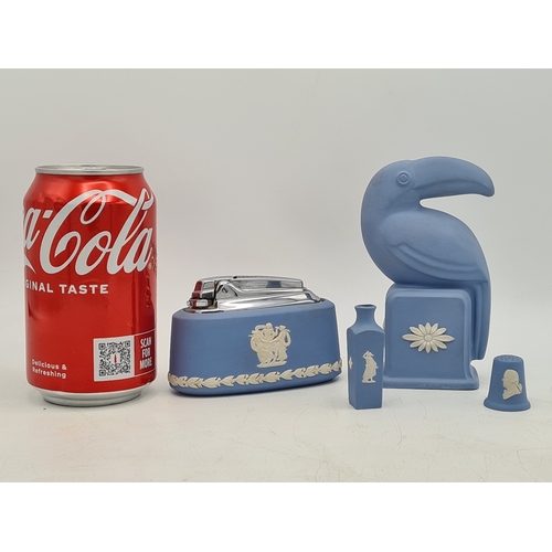 247 - A collection of 4 pieces of Wedgwood Jasperware in Blue. Includes a table lighter; a thimble; a mini... 