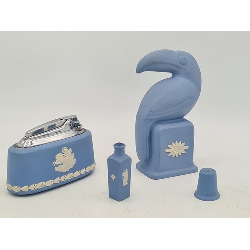 247 - A collection of 4 pieces of Wedgwood Jasperware in Blue. Includes a table lighter; a thimble; a mini... 