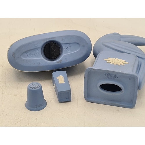 247 - A collection of 4 pieces of Wedgwood Jasperware in Blue. Includes a table lighter; a thimble; a mini... 