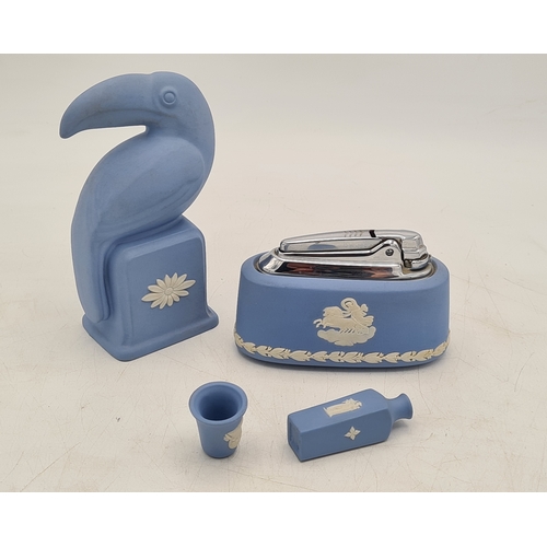 247 - A collection of 4 pieces of Wedgwood Jasperware in Blue. Includes a table lighter; a thimble; a mini... 