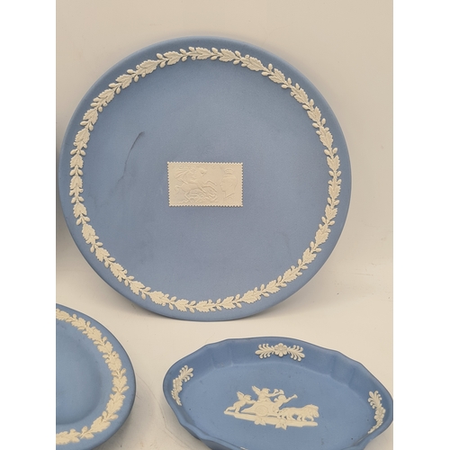 246 - A collection of 8 pieces of Wedgwood Jasperware in Blue. Includes a 1982 Christmas plate; a plate wi... 