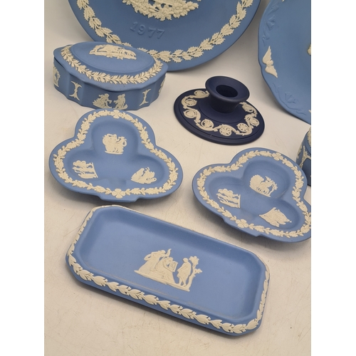 245 - A collection of 8 pieces of Wedgwood Jasperware in Blue. Includes a 1977 plate; a 1980 plate; 2 lidd... 