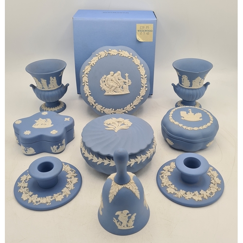 244 - A collection of 9 pieces of Wedgwood Jasperware in Blue. Includes 2 vases; 2 candlesticks; a bell an... 