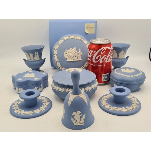 244 - A collection of 9 pieces of Wedgwood Jasperware in Blue. Includes 2 vases; 2 candlesticks; a bell an... 