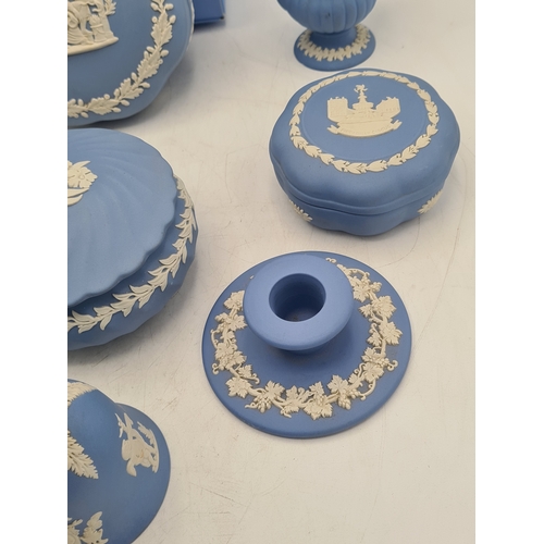 244 - A collection of 9 pieces of Wedgwood Jasperware in Blue. Includes 2 vases; 2 candlesticks; a bell an... 