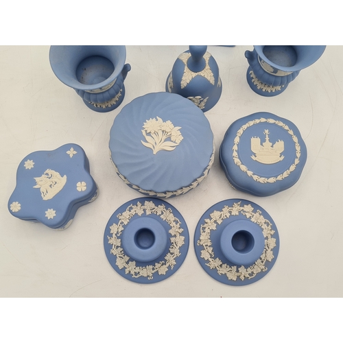 244 - A collection of 9 pieces of Wedgwood Jasperware in Blue. Includes 2 vases; 2 candlesticks; a bell an... 