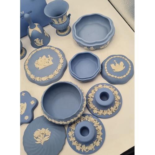 244 - A collection of 9 pieces of Wedgwood Jasperware in Blue. Includes 2 vases; 2 candlesticks; a bell an... 