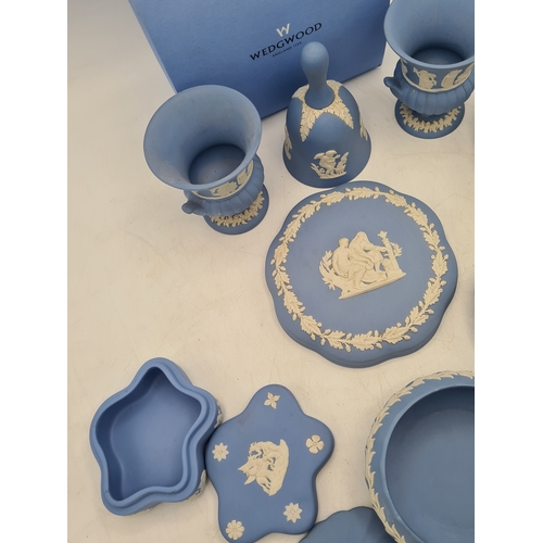244 - A collection of 9 pieces of Wedgwood Jasperware in Blue. Includes 2 vases; 2 candlesticks; a bell an... 