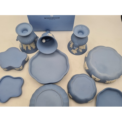 244 - A collection of 9 pieces of Wedgwood Jasperware in Blue. Includes 2 vases; 2 candlesticks; a bell an... 