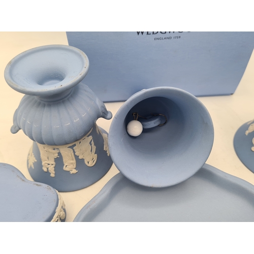 244 - A collection of 9 pieces of Wedgwood Jasperware in Blue. Includes 2 vases; 2 candlesticks; a bell an... 