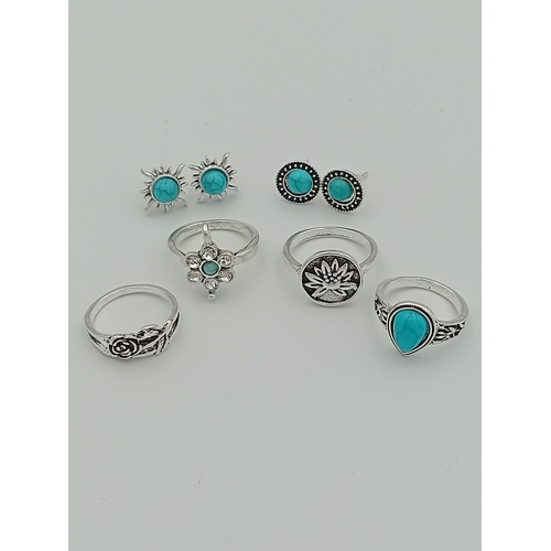 355 - A job lot of 4 white metal rings and 2 pairs of white metal earrings with turquoise coloured stones