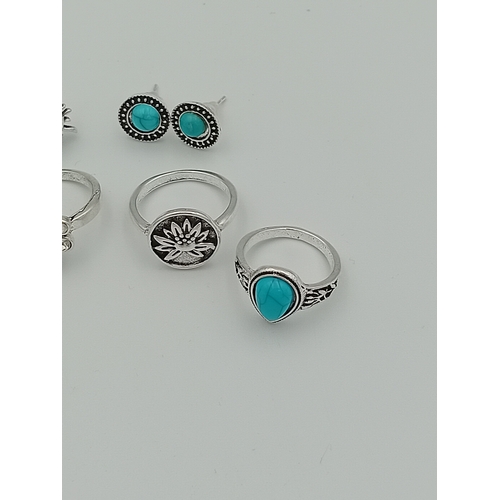 355 - A job lot of 4 white metal rings and 2 pairs of white metal earrings with turquoise coloured stones