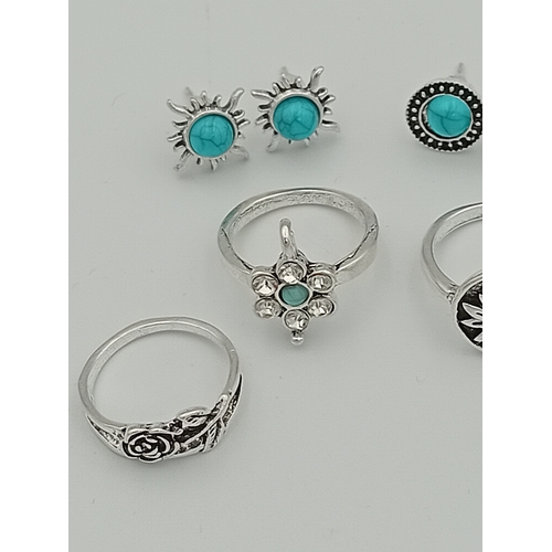 355 - A job lot of 4 white metal rings and 2 pairs of white metal earrings with turquoise coloured stones