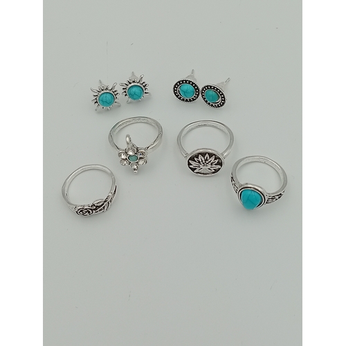 355 - A job lot of 4 white metal rings and 2 pairs of white metal earrings with turquoise coloured stones