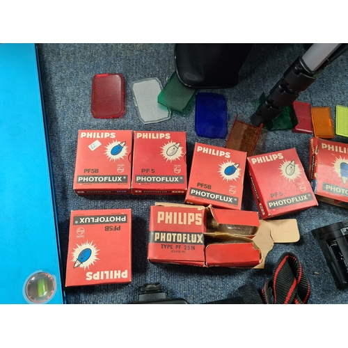 43 - A collection of photographic equipment to include: coloured filters; light bulbs, a tripod and level... 