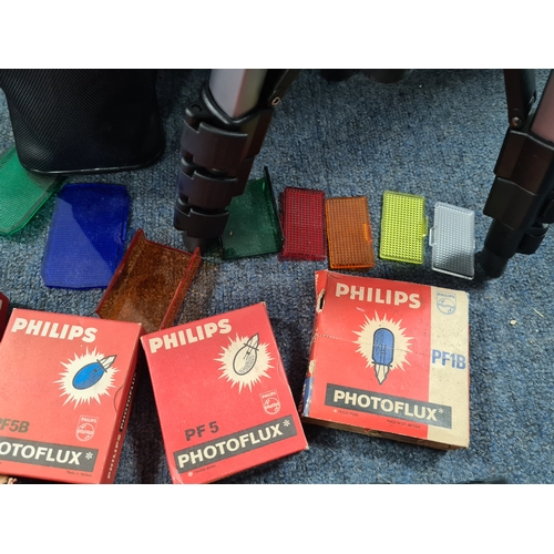 43 - A collection of photographic equipment to include: coloured filters; light bulbs, a tripod and level... 