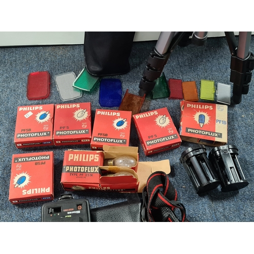 43 - A collection of photographic equipment to include: coloured filters; light bulbs, a tripod and level... 