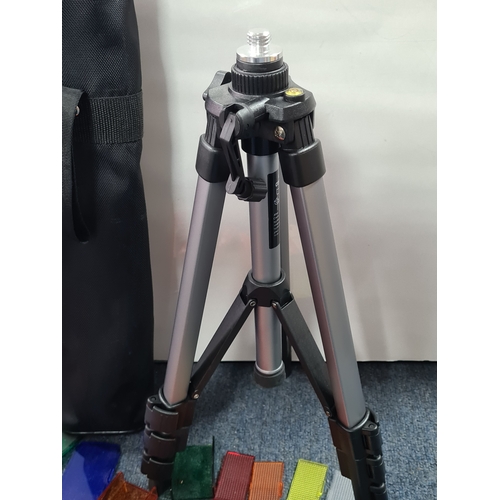 43 - A collection of photographic equipment to include: coloured filters; light bulbs, a tripod and level... 
