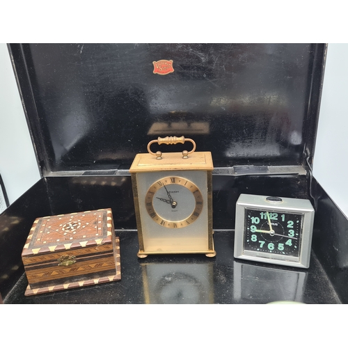 52 - A job lot of small items housed in a large black cash box (no key), items include clocks, various bo... 