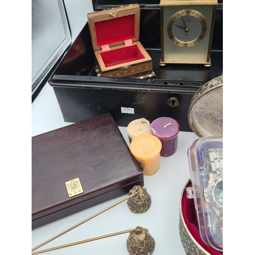 52 - A job lot of small items housed in a large black cash box (no key), items include clocks, various bo... 
