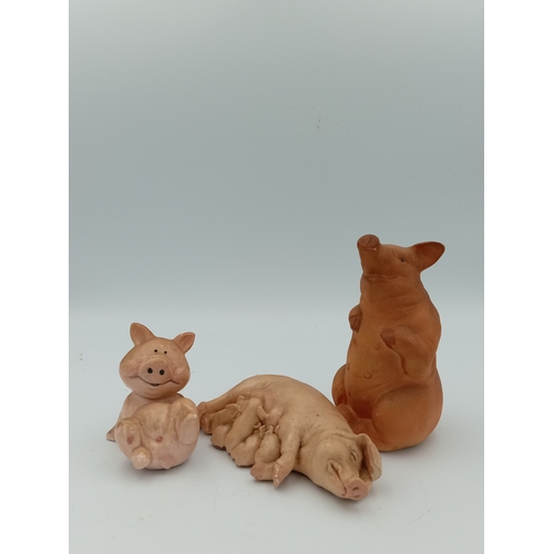 58 - A box full of pig figurines. Including a large collection of pig figures including a figure of 3 pig... 