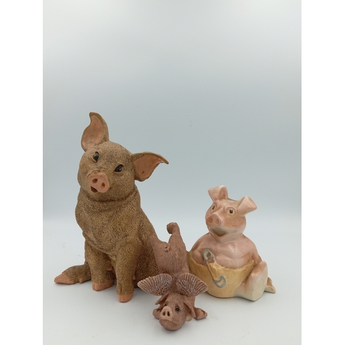 58 - A box full of pig figurines. Including a large collection of pig figures including a figure of 3 pig... 
