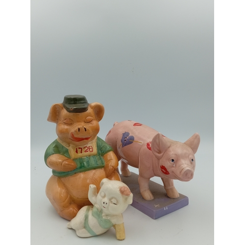 58 - A box full of pig figurines. Including a large collection of pig figures including a figure of 3 pig... 