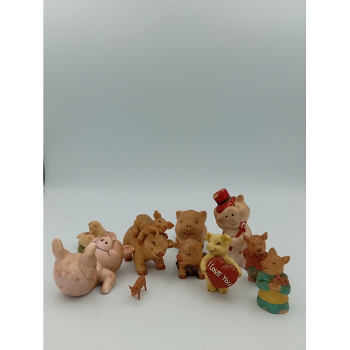 58 - A box full of pig figurines. Including a large collection of pig figures including a figure of 3 pig... 
