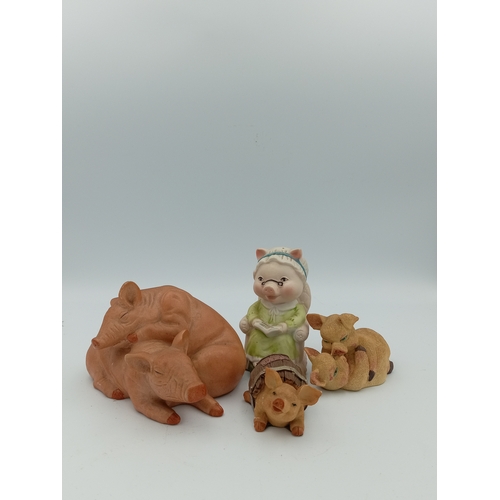 58 - A box full of pig figurines. Including a large collection of pig figures including a figure of 3 pig... 