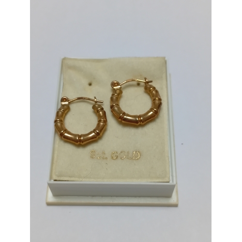 341 - A pair of hallmarked 375 9ct gold bamboo style hoop earrings.