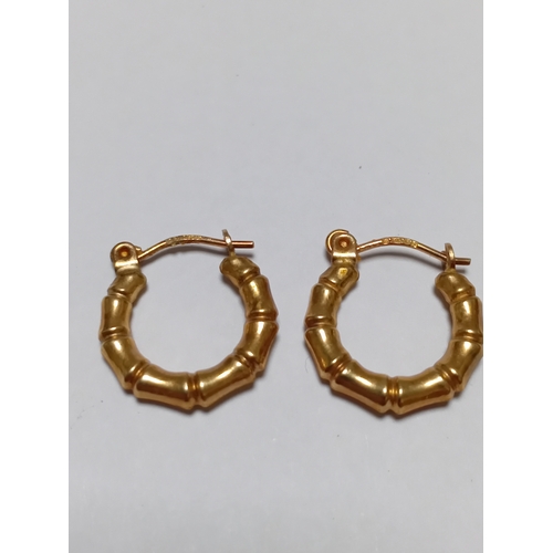 341 - A pair of hallmarked 375 9ct gold bamboo style hoop earrings.