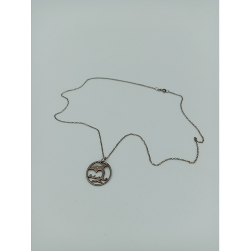 367 - A dolphin pendant made from a coin on a stamped 925 silver chain.